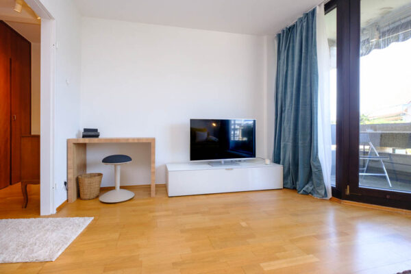 Wohnzimmer mit Blick auf Arbeitsplatz und Fernseher